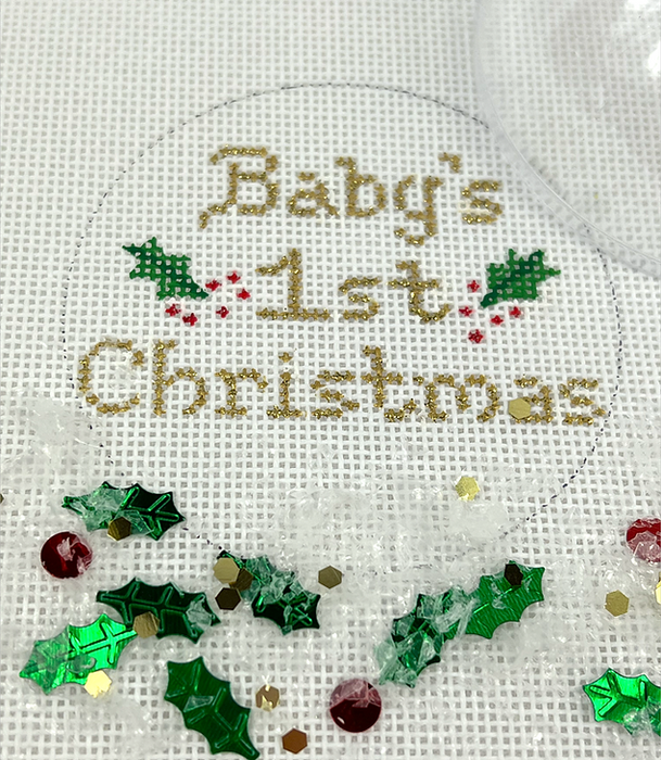 Christmas Ornament w/ Clear Dome Cover & Confetti – “Baby’s 1st  Christmas” w/ Holly – gold letters